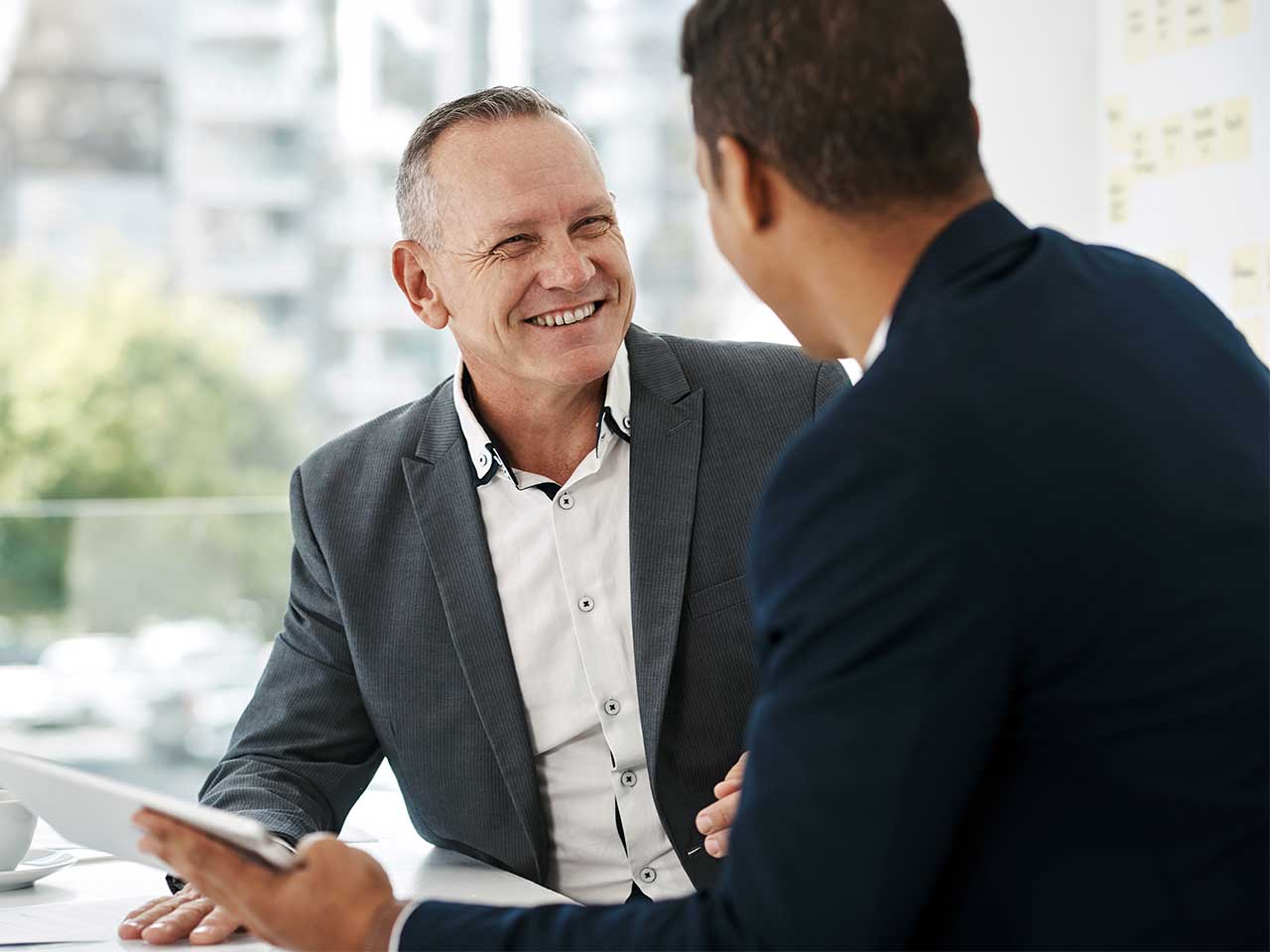 Financial consultant explaining IRA and Roth IRA options to a client