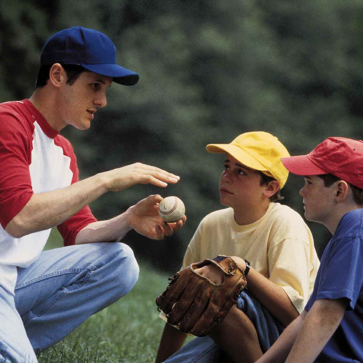 baseball-coach-teaching-young-players