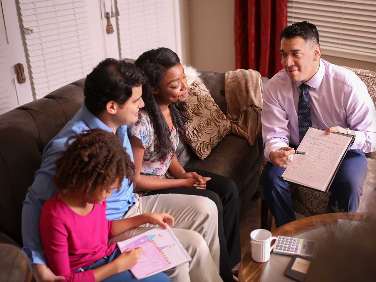 Financial advisor meeting with a family to discuss savings and investing goals