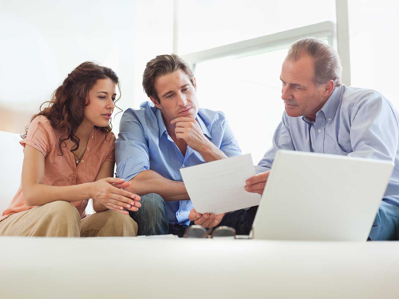 Advisor reviewing a transparent fee summary sheet with clients