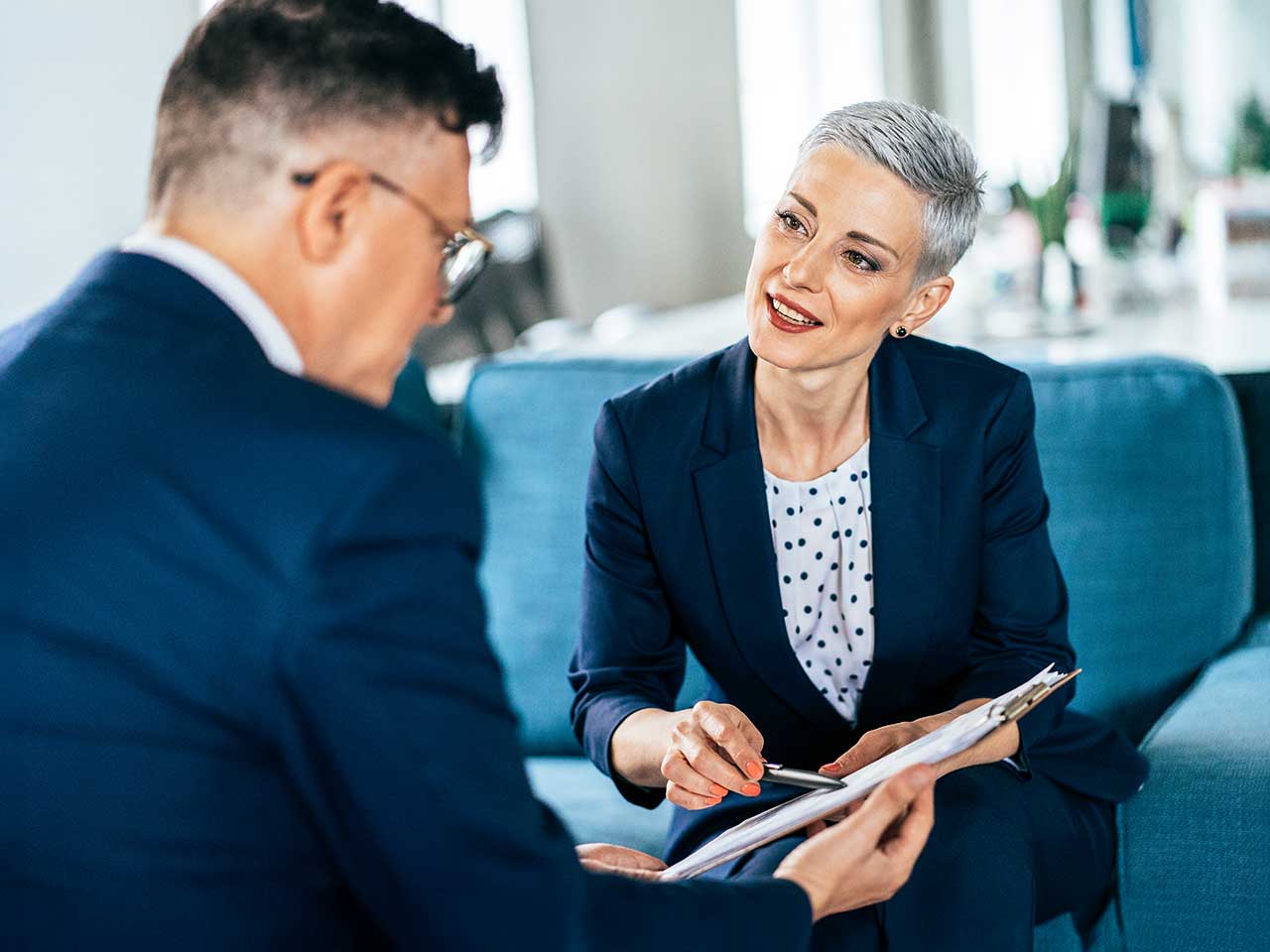 Financial advisor and client reviewing a plan in a calm, professional setting