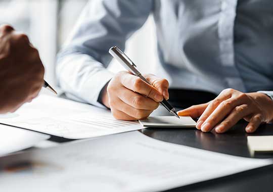 Client and advisor reviewing IRA contribution and timeline notes