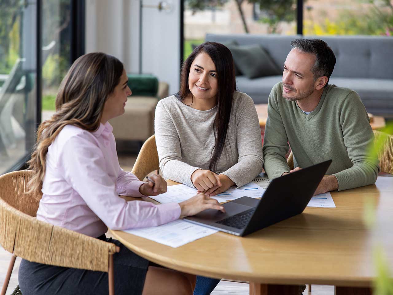 Advisor and clients reviewing financial documents and creating a wealth management roadmap